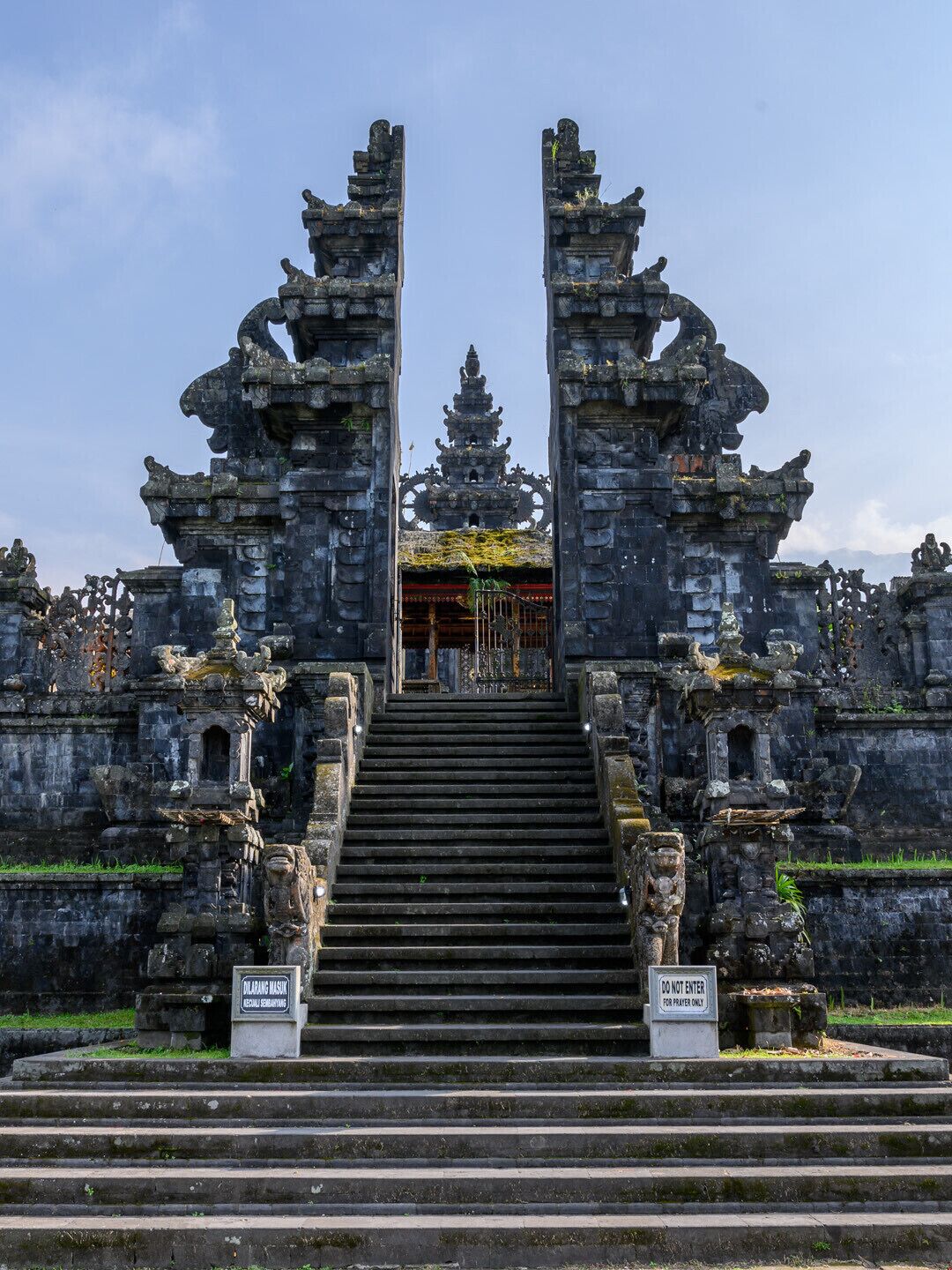 A temple entrance with stone staircases and ornate carvings.