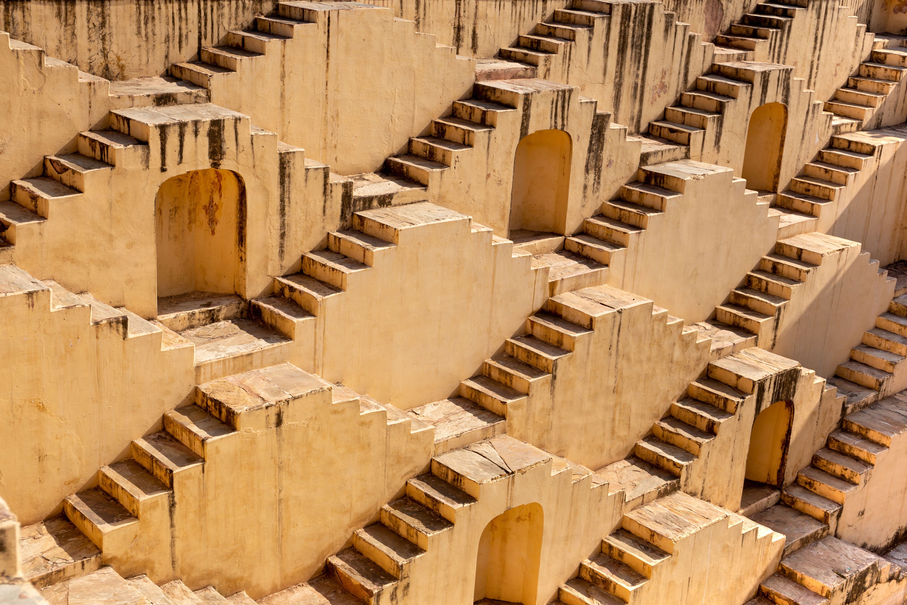 A series of stone steps with arched openings, likely part of a historical or cultural site.