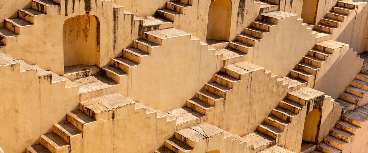 A series of stone steps with arched openings, likely part of a historical or cultural site.