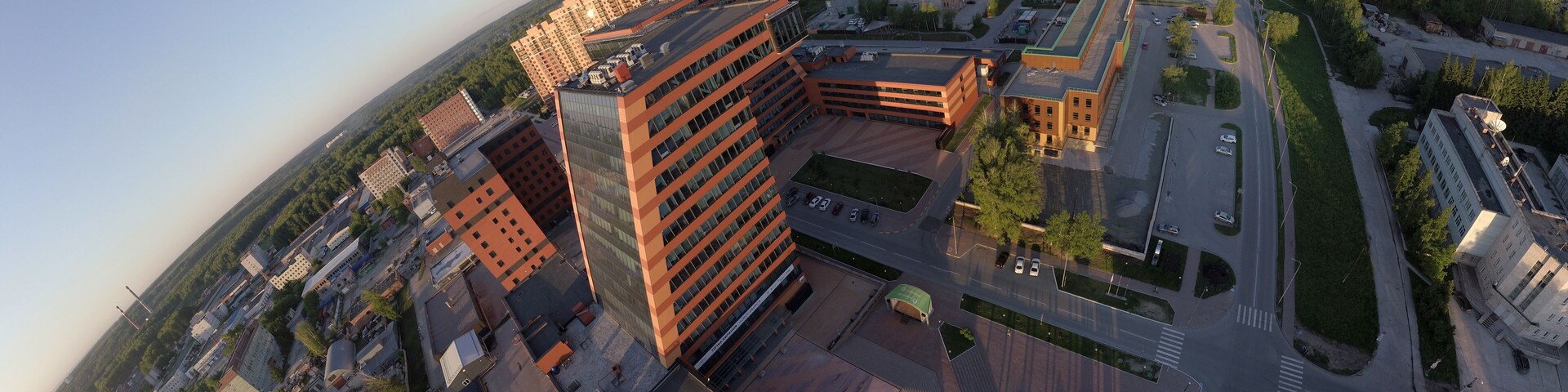 A large building with laboratories and innovative projects, inventions in the Technopark of the Novosibirsk Academic Township in the view of the part of the planet from aerial panorama photo