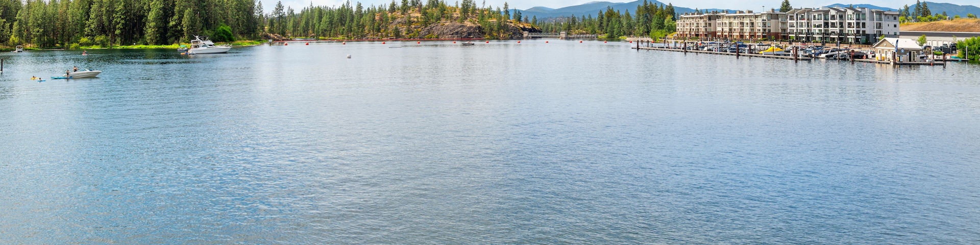 Waterfront condominiums along the Spokane River across from Q'Emiln Park and the Avista island Dam at Falls Park in Post Falls, Idaho USA.