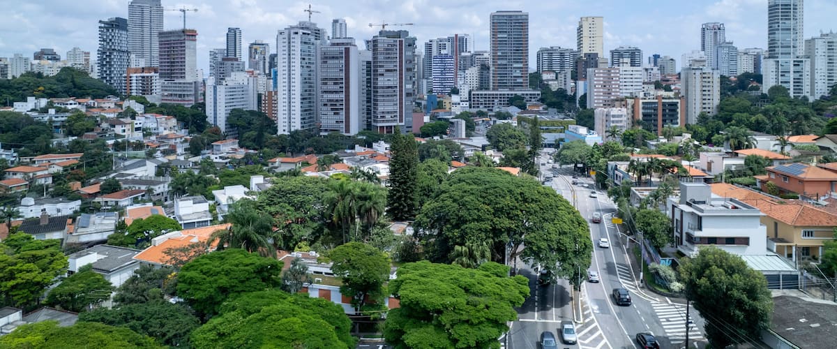 A cityscape with high-rise buildings, a mix of residential and commercial structures, and a clear sky.