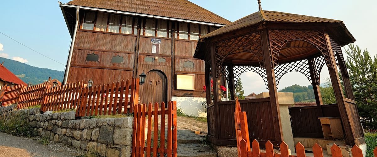 A wooden building with a tiled roof and a wooden fence.