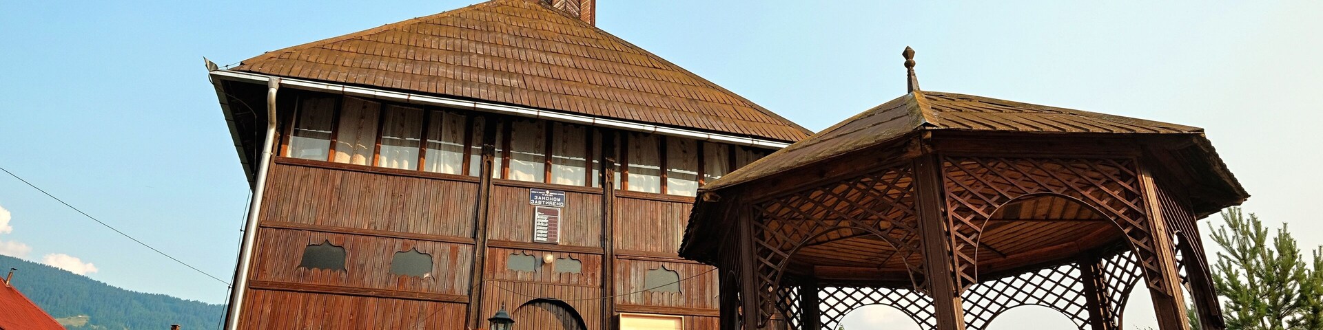 A wooden building with a tiled roof and a wooden fence.