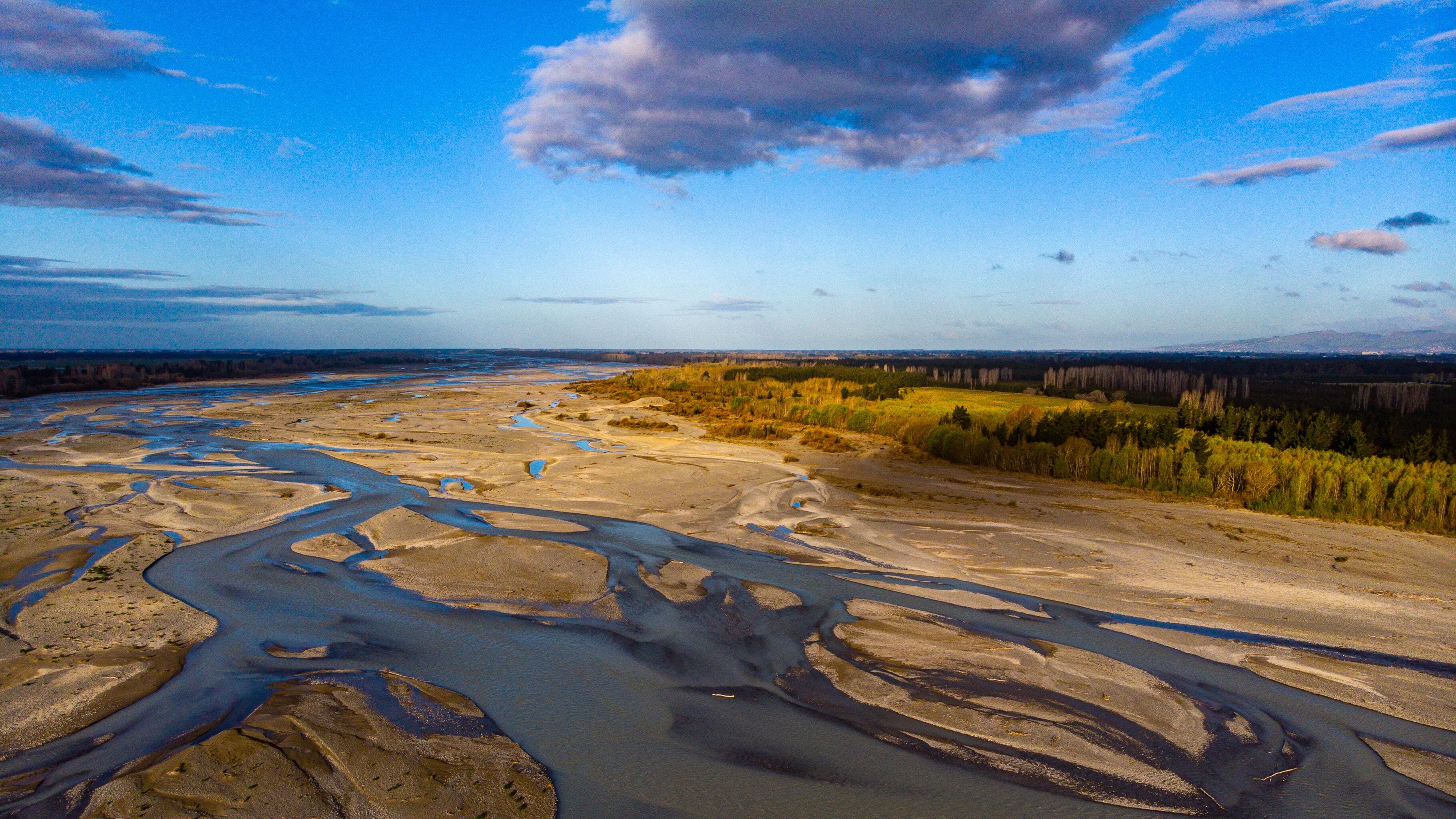 aerial panorama of waimakariri river near christchurch, north canterbury, new zealand; sunset over beautiful river