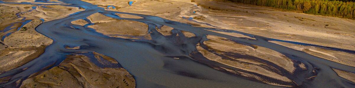 aerial panorama of waimakariri river near christchurch, north canterbury, new zealand; sunset over beautiful river