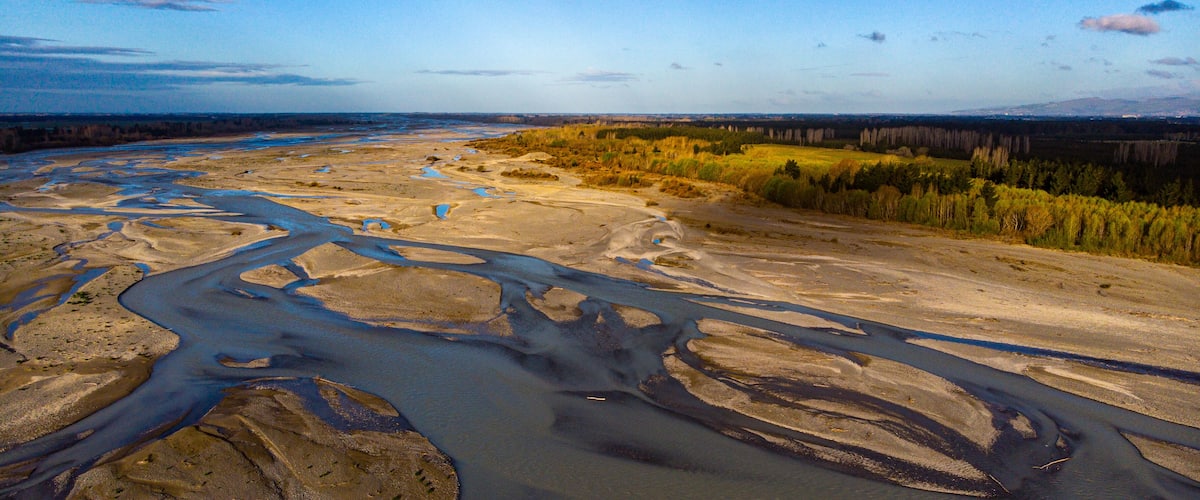 aerial panorama of waimakariri river near christchurch, north canterbury, new zealand; sunset over beautiful river