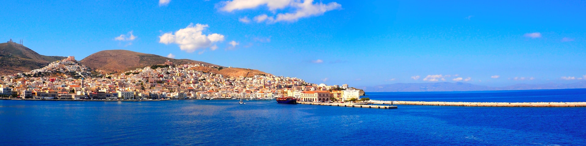 superb panoramic view of the port of Tinos, magnificent Cyclades island in the heart of the Aegean Sea, dominated by the Panaghia Evangélistria Church