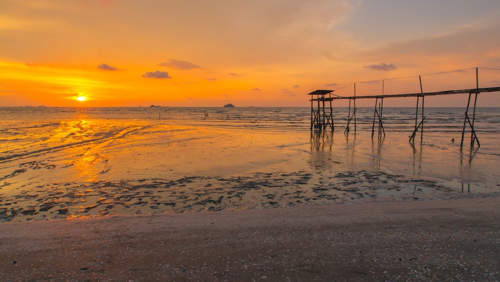 Scenery of sunset captured at Pantai Remis, Selangor, Malaysia. The motion of cloud and water is due to long exposure effect. Low light