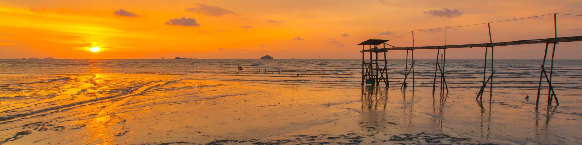 Scenery of sunset captured at Pantai Remis, Selangor, Malaysia. The motion of cloud and water is due to long exposure effect. Low light