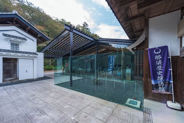 A traditional Japanese building with a modern glass extension.