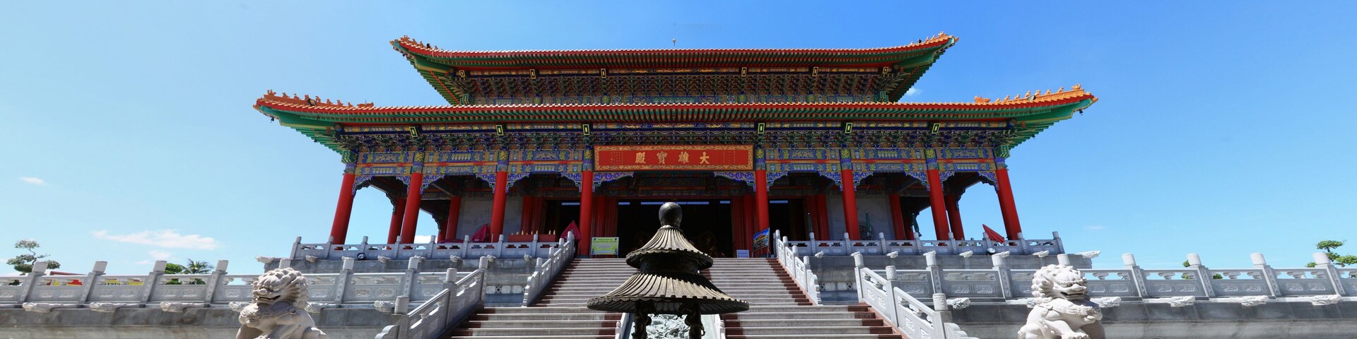 A traditional Chinese building with a red roof and ornate decorations.