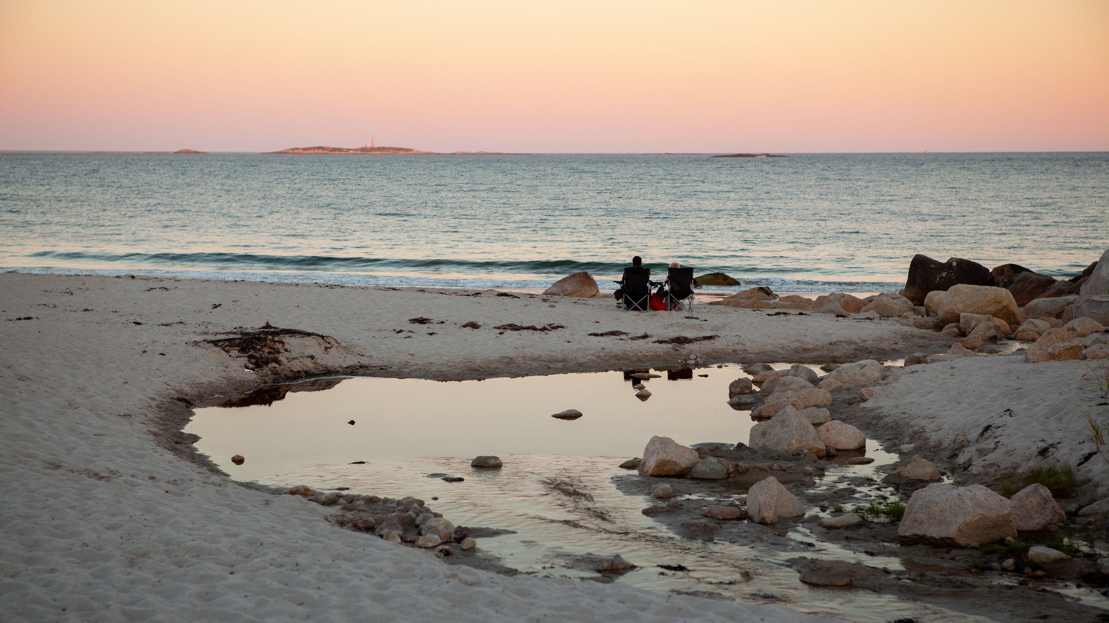 Crystal Crescent Beach showing a sunset, a sandy beach and general coastal views