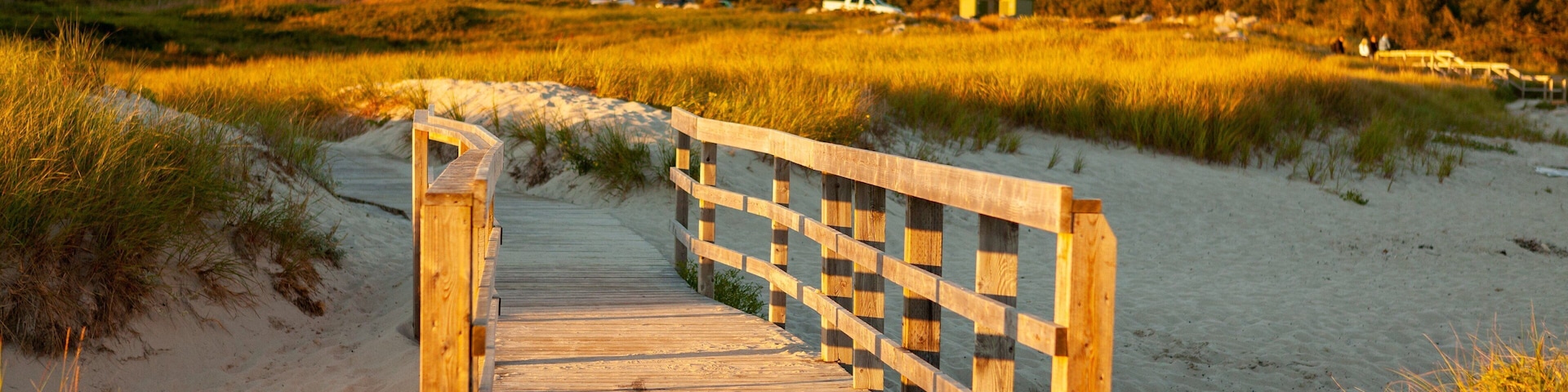 Crystal Crescent Beach featuring a sunset, a sandy beach and a bridge