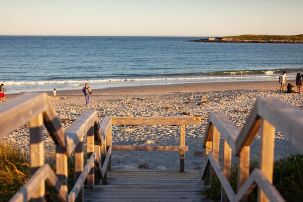 Crystal Crescent Beach which includes a sandy beach, general coastal views and a sunset