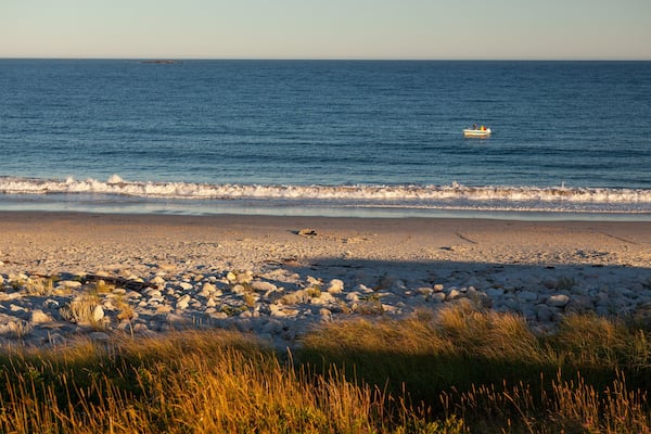 Crystal Crescent Beach which includes general coastal views, a sunset and a sandy beach