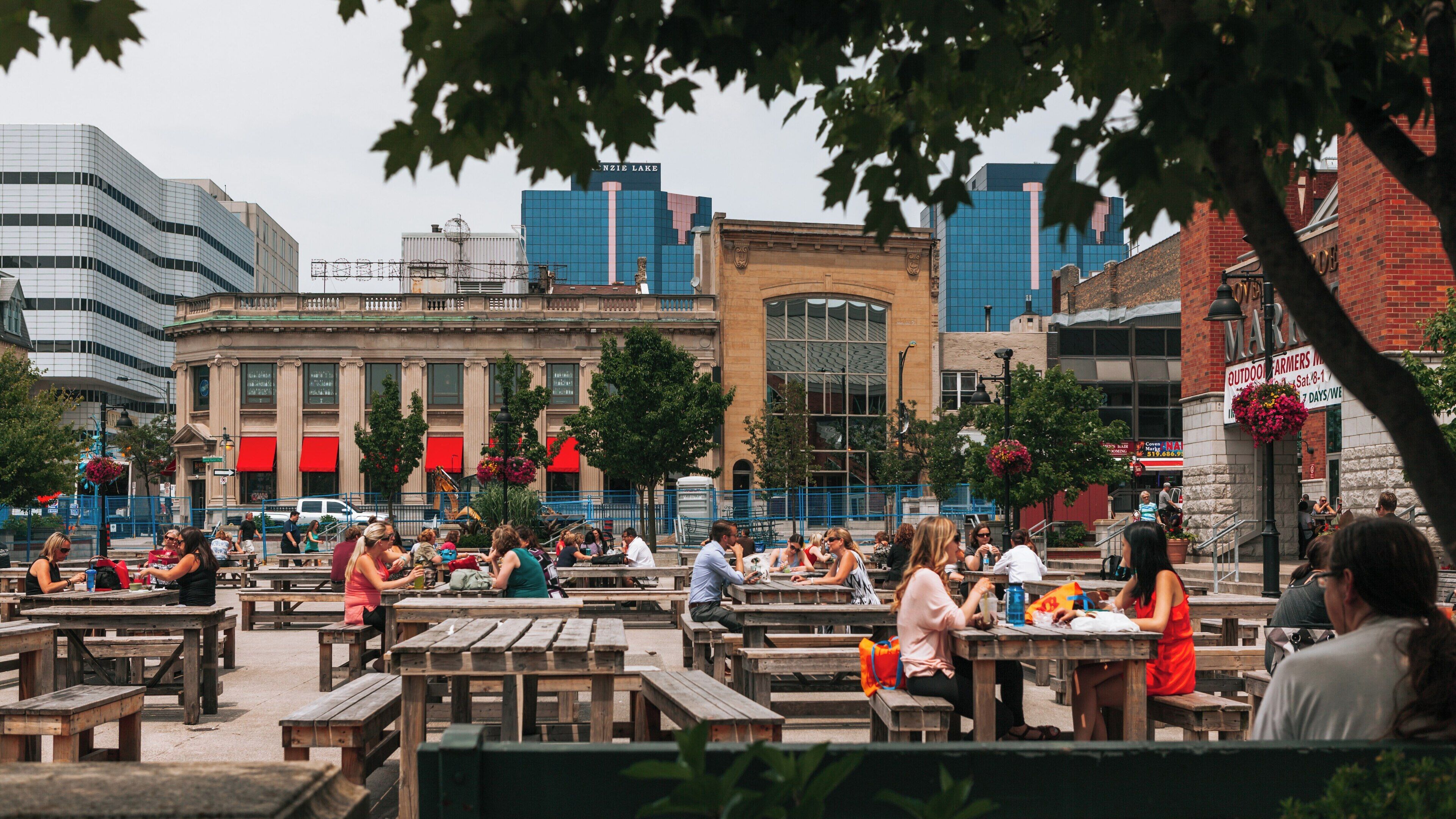 Vibrant outdoor gathering at Covent Garden Market in downtown London Ontario showcasing lively atmosphere and community interactions