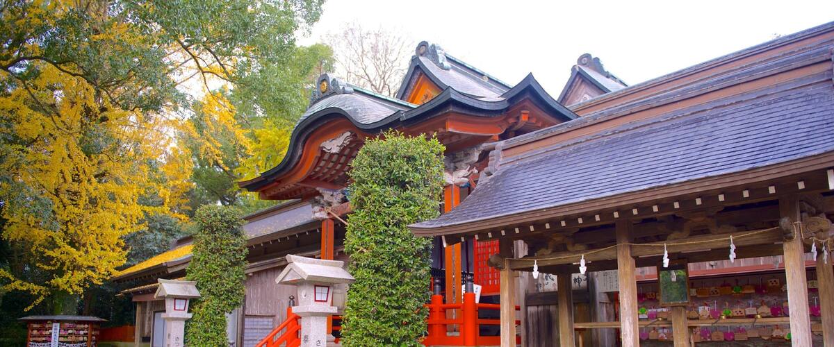 A traditional Japanese building with a tiled roof, red accents, and a stone staircase.
