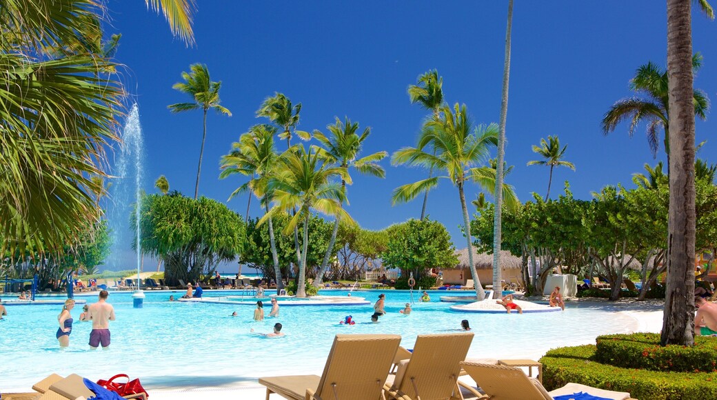 Arena Gorda Beach showing tropical scenes and a pool as well as a small group of people