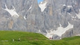 Un paysage montagneux caractérisé par des falaises rocheuses et des zones recouvertes de neige.