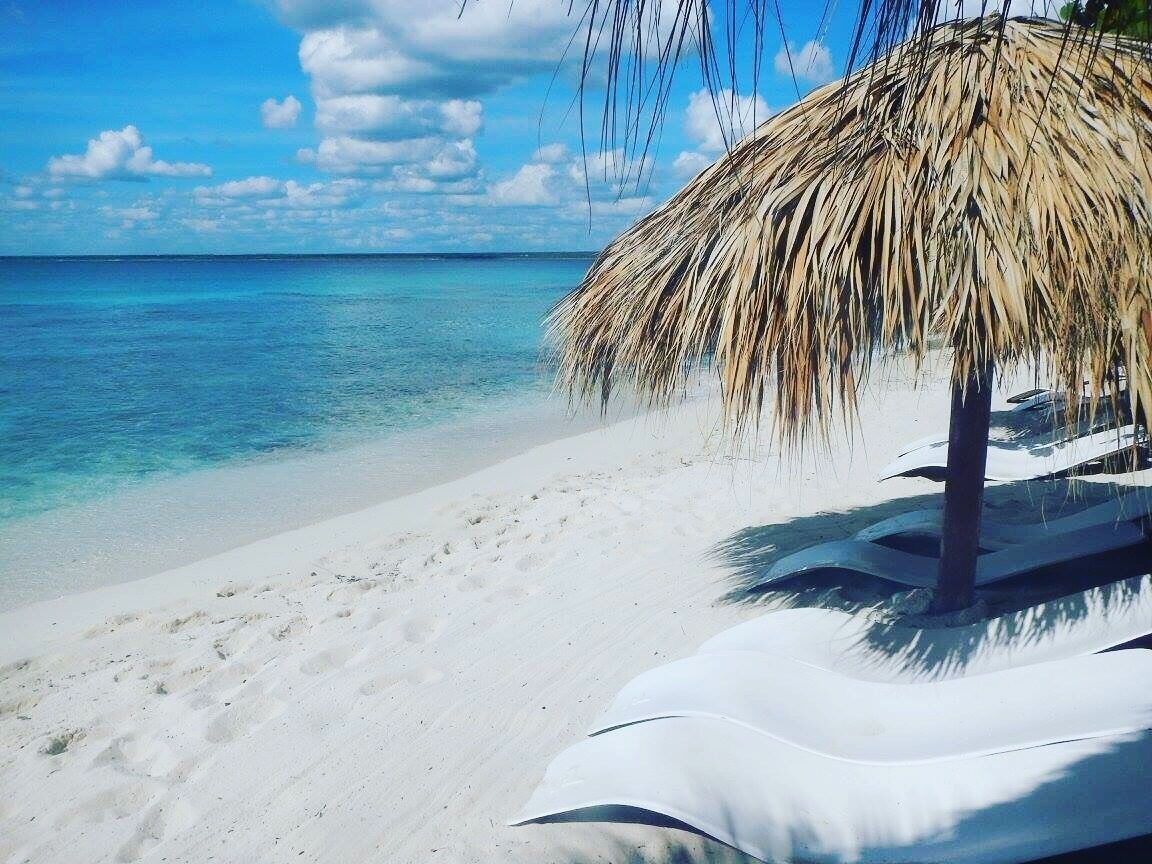 Clear blue water and white sand beach