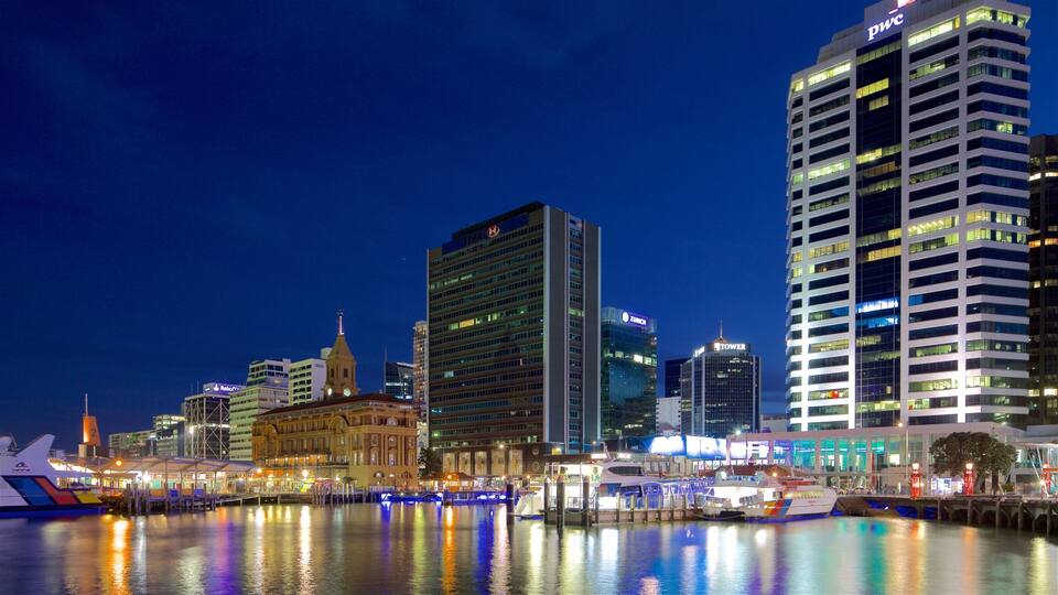Auckland Ferry Terminal which includes night scenes, cbd and a marina