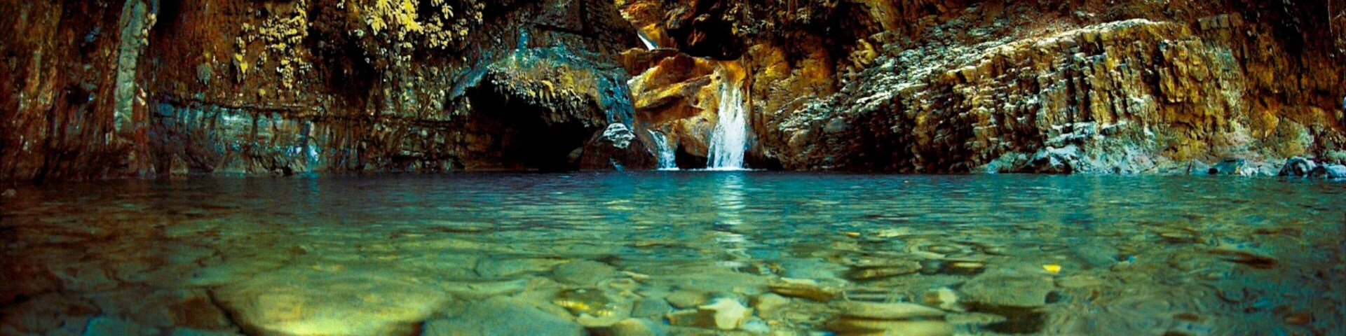 Dominican Republic featuring a gorge or canyon, a waterfall and a lake or waterhole