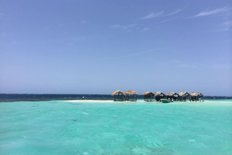 Overwater bungalows on a clear turquoise sea.