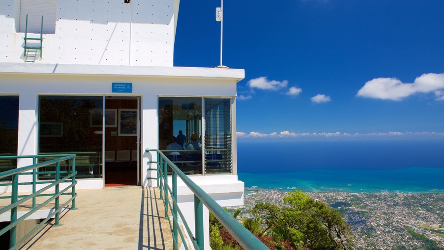 A coastal building with a view of the ocean and a cityscape.