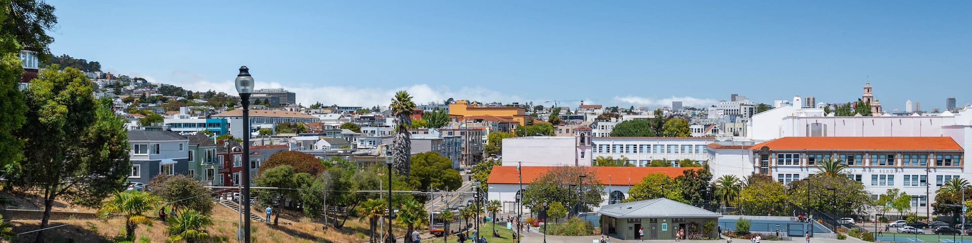 Mission Dolores Park showing picnicing and a park as well as a small group of people