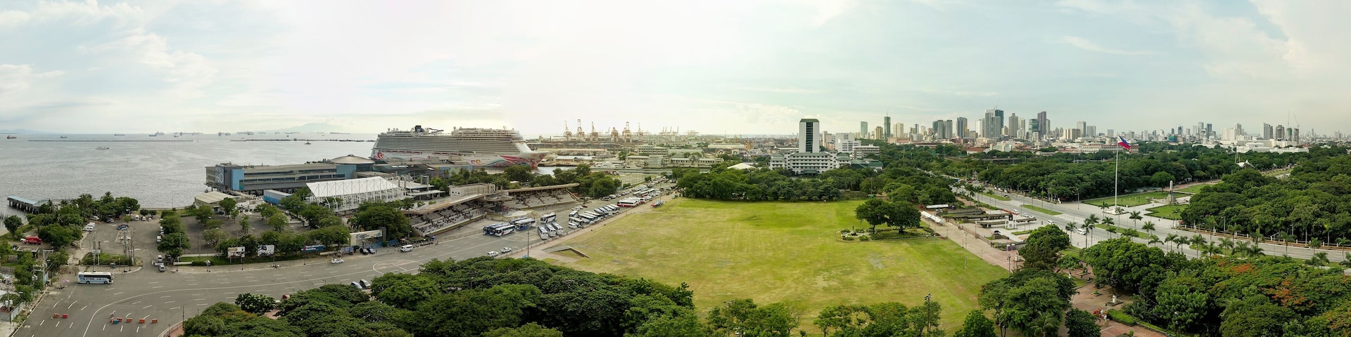 Manila, Philippines - July 2020: Panorama Aerial of Quirino Grandstand and Rizal Park. Port of Manila, Manila Hotel and Binondo Skyline visible in photo.