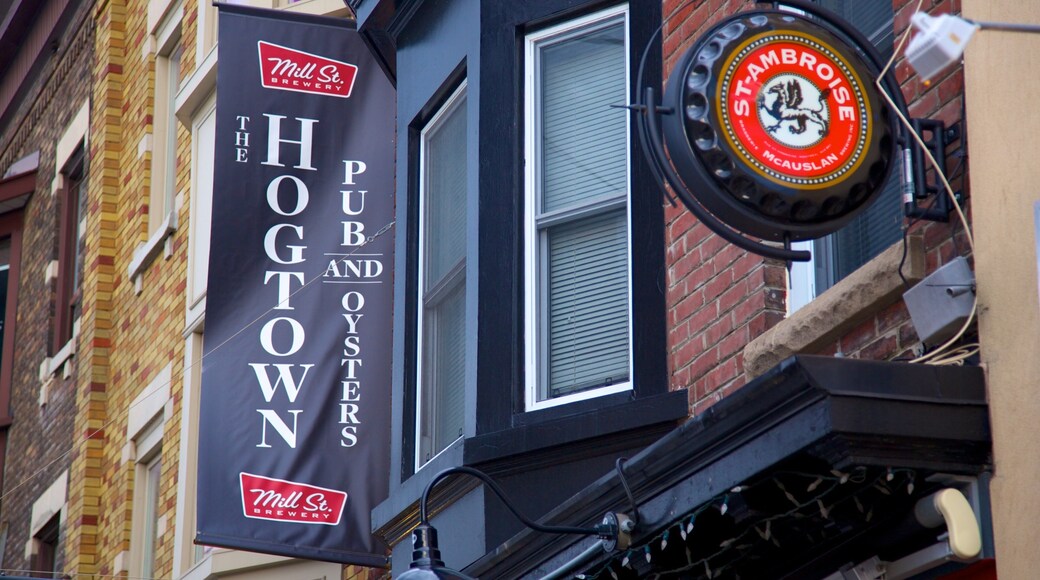 Little Italy showing a bar and signage