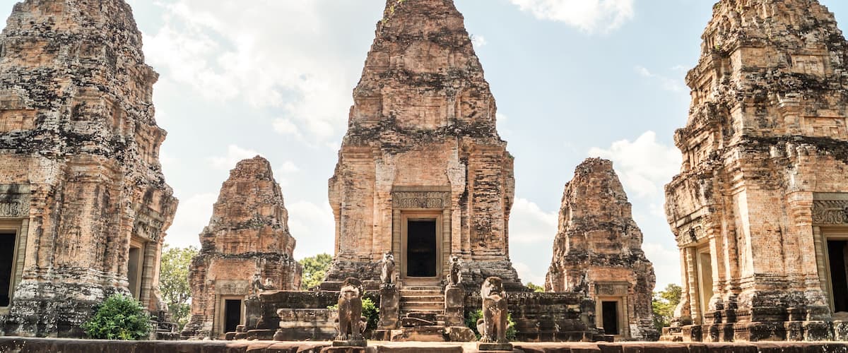 A temple complex with multiple towering structures and a central doorway.