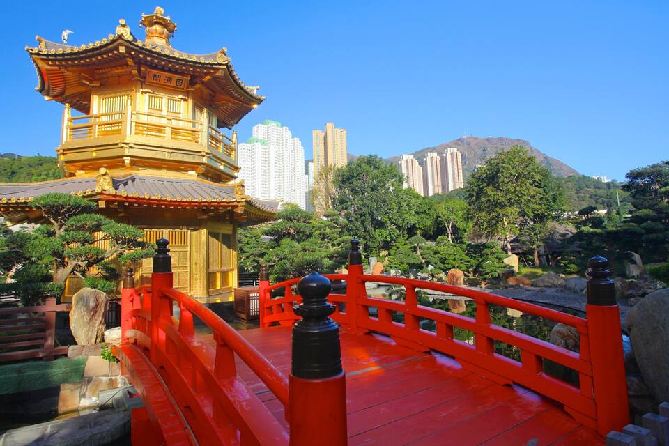 A traditional Chinese pagoda with a red bridge in the foreground.