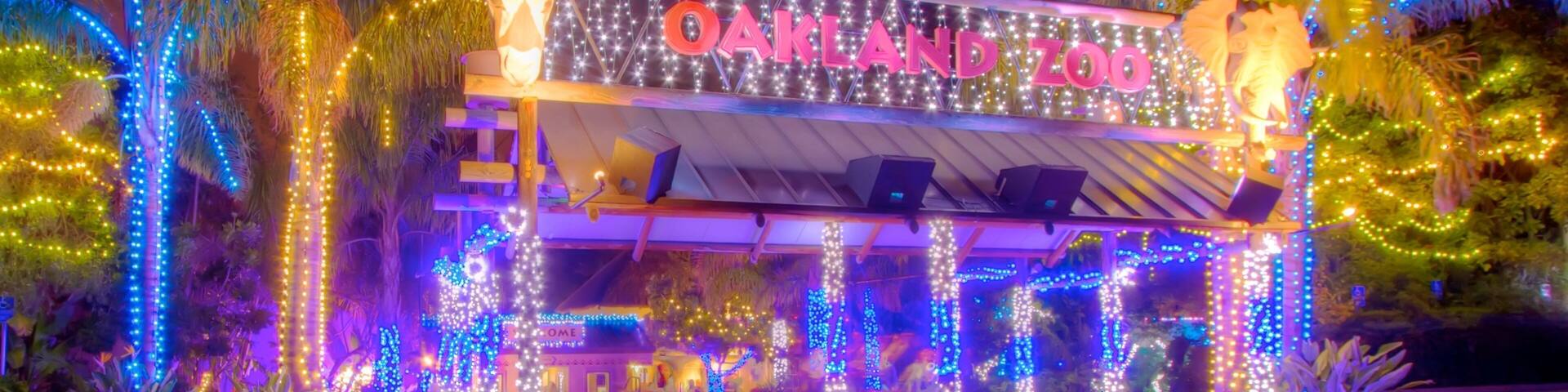 Oakland Zoo featuring night scenes, signage and zoo animals