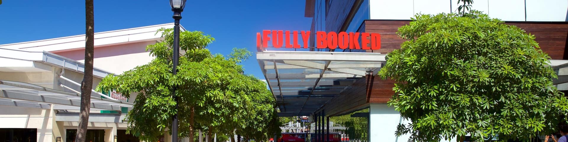 A shopping area with a 'Fully Booked' sign, potted plants, and a covered walkway.