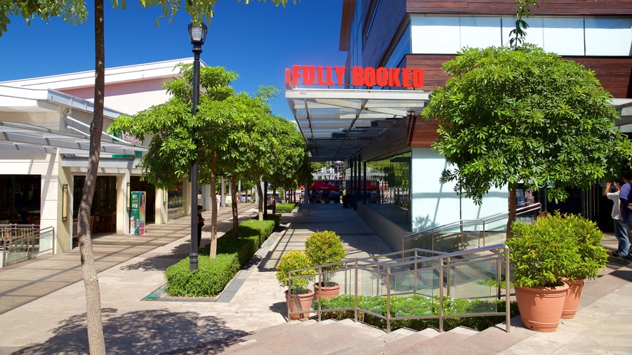 A shopping area with a 'Fully Booked' sign, potted plants, and a covered walkway.