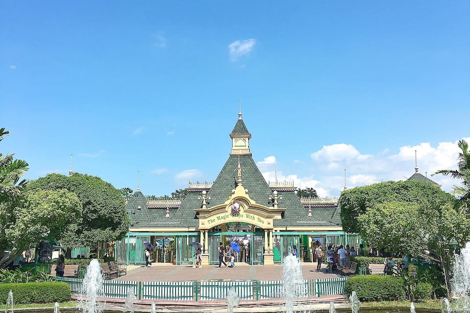 A green-roofed building with a sign reading "The Magic Kingdom."