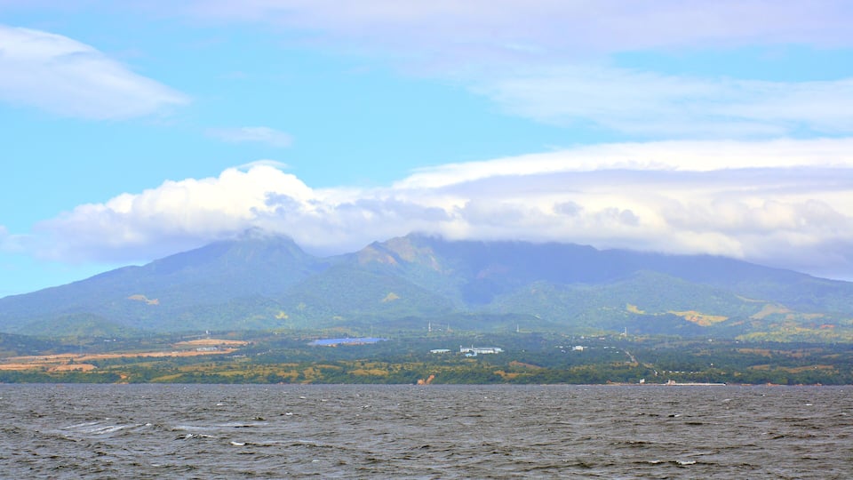 A mountain range with a lake in the foreground.