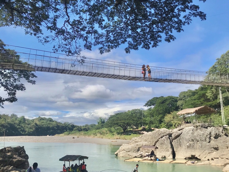 MINALUNGAO NATIONAL PARK
3-4hours drive from Manila
Unexpected treasure hidden deep
in the province of General Tinio Nueva Ecija.
Photo shows 2 locale men manouver the indegenous bamboo Raft full of Excursionist by paddle and another Guy pulling the rope while jumping alongside the rockies and help navigate the River.
Crossing the Penaranda River thru hanging Bridge, Ziplining and walk 1000 steps thru the woods towards the top of the Hills are few activities this place has to offer for a day visit.
Good for outdoor enthusiast.