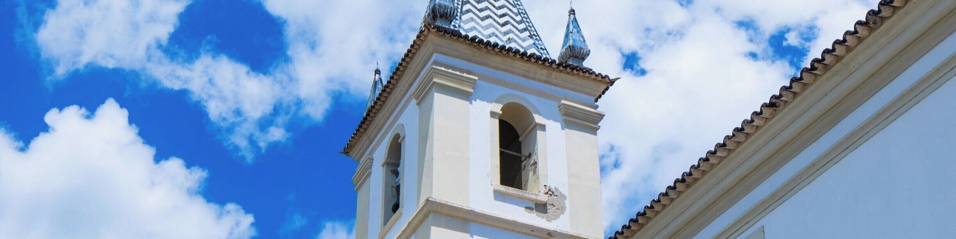 A bell tower of Igreja Matriz de Nossa Senhora do Rosário. The tiling pattern is found in two other bell towers in the region. Cachoeira, Bahia, Brazil.