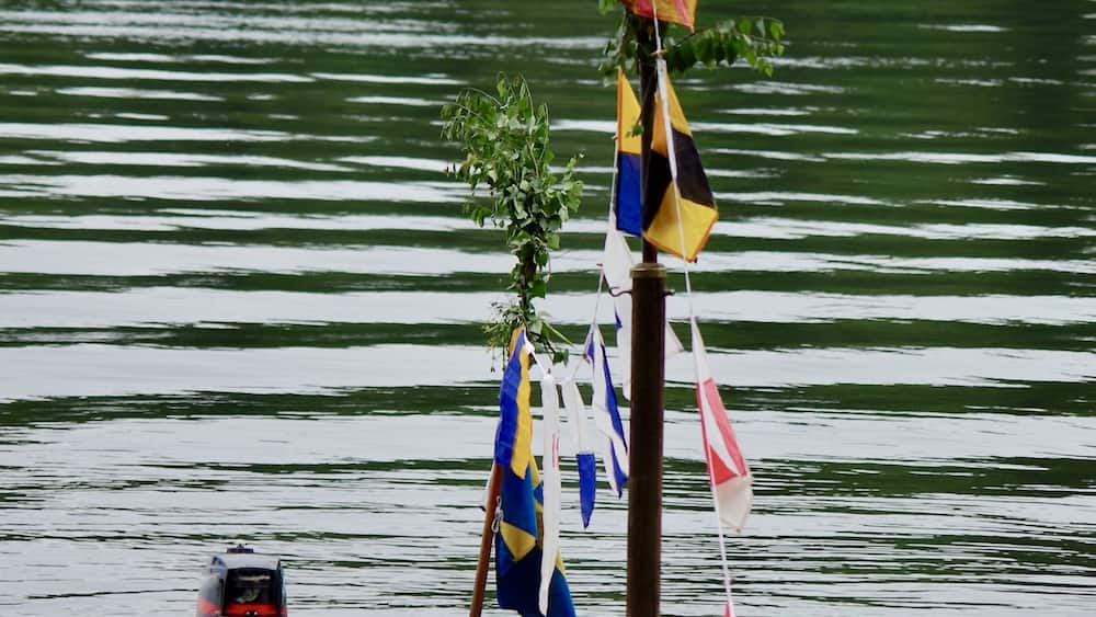 Decorated sailboat mast at midsummer holiday in Sweden.