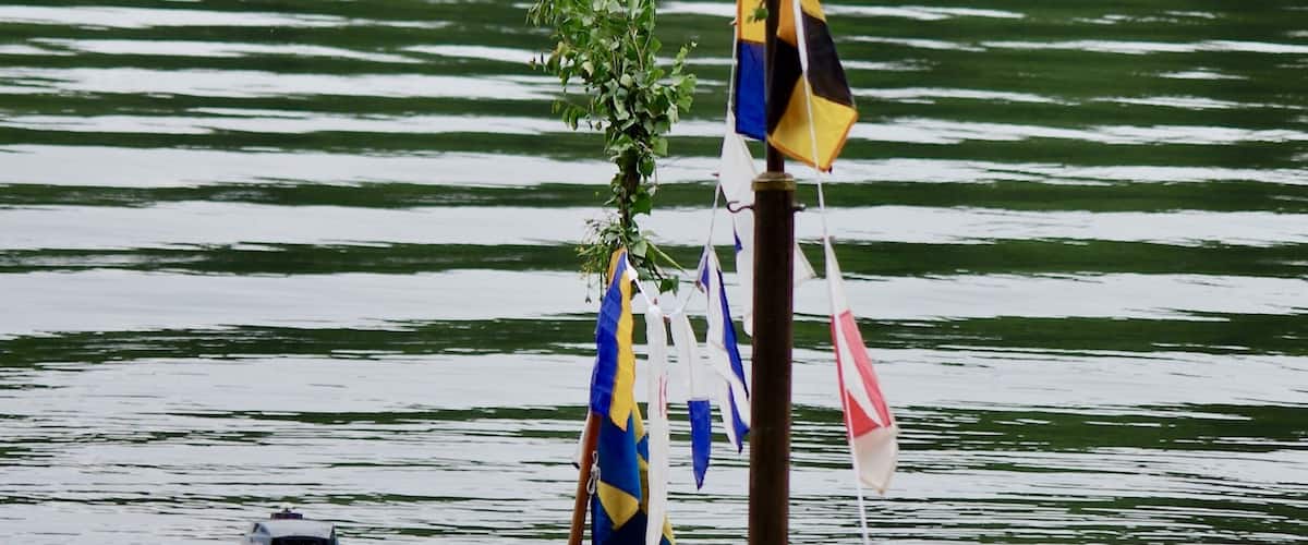 Decorated sailboat mast at midsummer holiday in Sweden.