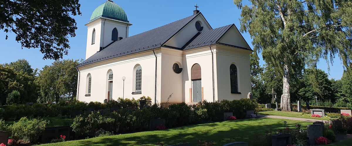 A church with a green dome and a bell tower.