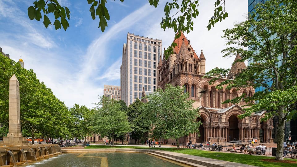 Trinity Church Boston which includes heritage architecture and a pond