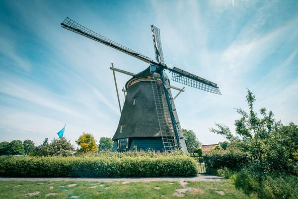 old Dutch windmill, Amsterdam De Riekermolen, Amstelpark, Amstel River