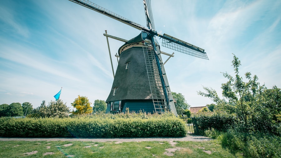 old Dutch windmill, Amsterdam De Riekermolen, Amstelpark, Amstel River