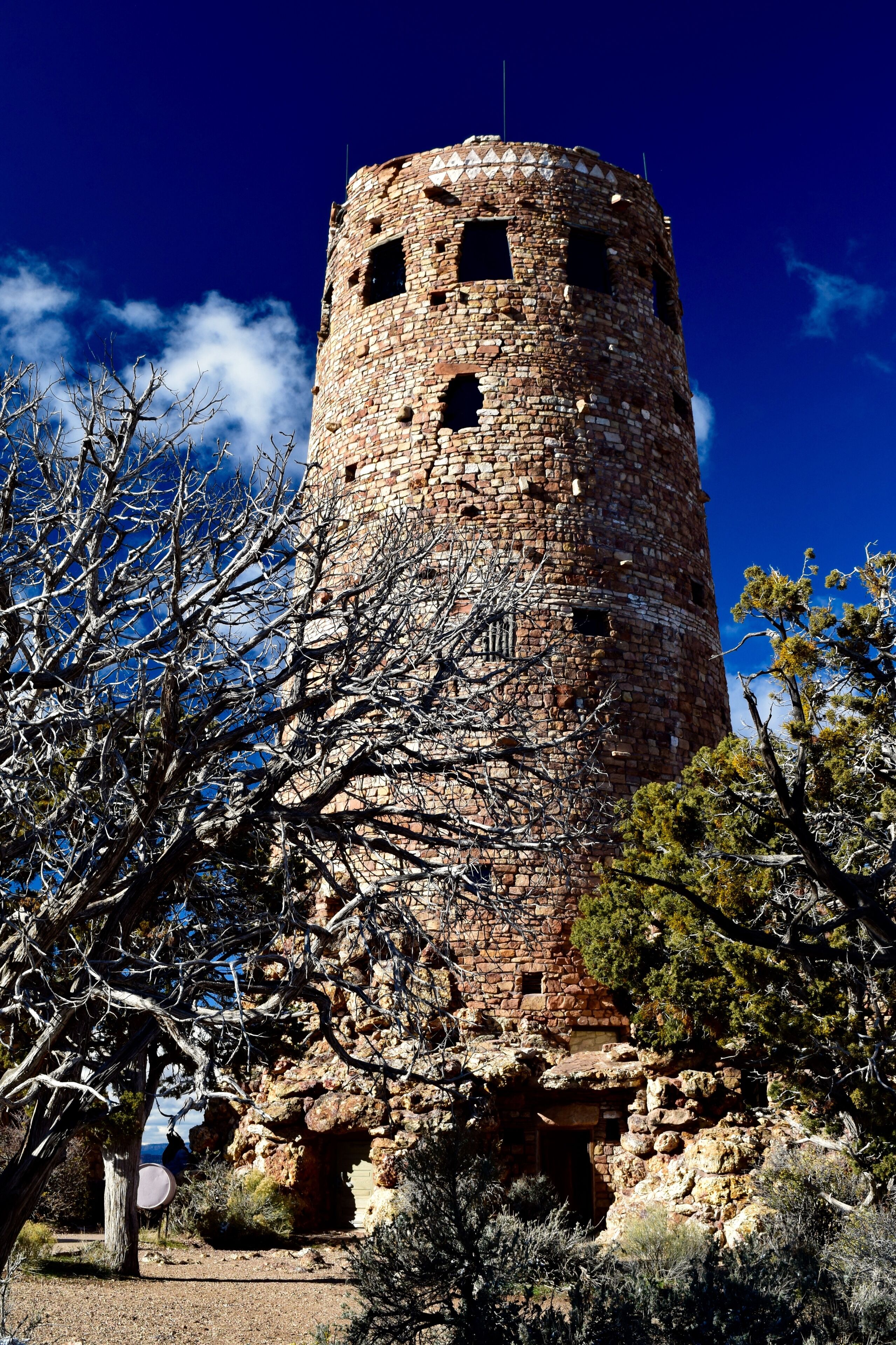 The Desert View Watchtower was designed by architect Mary Colter and mimics the style of Ancestral Puebloan towers. There are 85 steps you can climb inside the tower to take in the view from 70 feet above the observation area. Below, you’ll see the Colorado River at the bottom of the canyon and sweeping views to the east and west. There are large parking lots, a gift shop, a cafe and restrooms located around the immediate area. The overlook is accessible but not the structure itself. 
#GrandCanyon #Perspectives