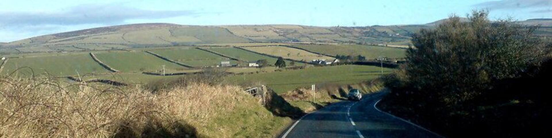 In the Preseli foothills Mynydd Castlebythe is the furthest hill visible. The road that leads to Letterston veers off to the left in the distance.