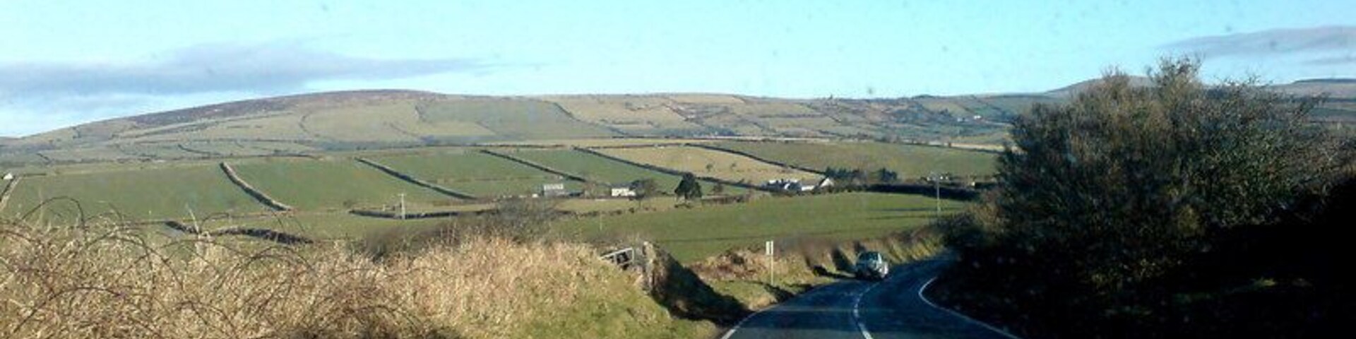 In the Preseli foothills Mynydd Castlebythe is the furthest hill visible. The road that leads to Letterston veers off to the left in the distance.